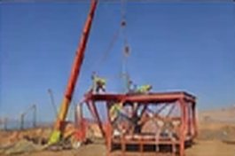 Crane lowering a watchtower cabin into place