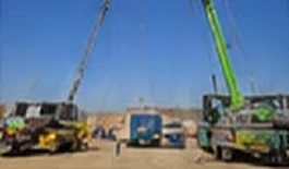 Cranes and trucks staged at the relocation site