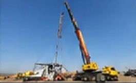 Mobile crane beside a tower under relocation