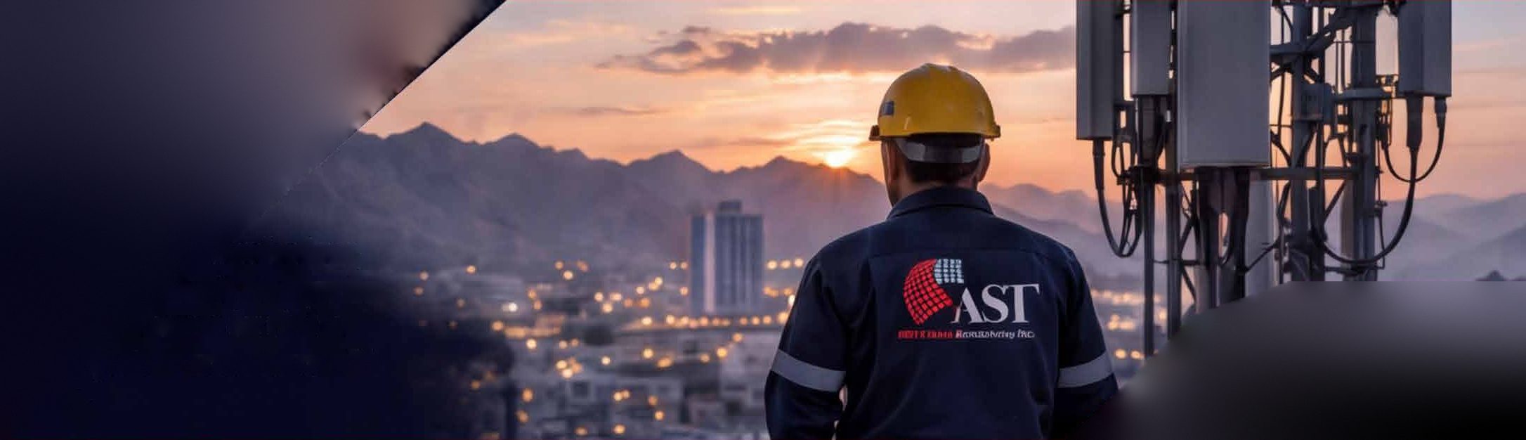 AST engineer looking over Muscat at sunset beside a telecom mast